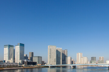 Fototapeta na wymiar High-Rise Buildings on the Waterfront against the Blue Sky