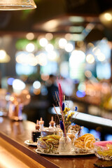 Beautiful composition of dried flowers from dried fruits in glassware on a bar counter in a restaurant