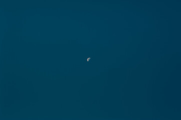 The crescent moon in the sky during twilight