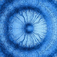 intricate patterns and unique cırcular designs from dark blue paint drips on a light blue textured wall