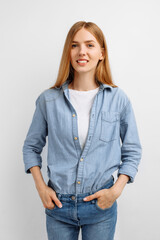 happy young woman posing and looking at camera on white background