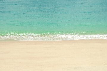 Soft blue ocean wave on clean sandy beach. Sea view from tropical beach.