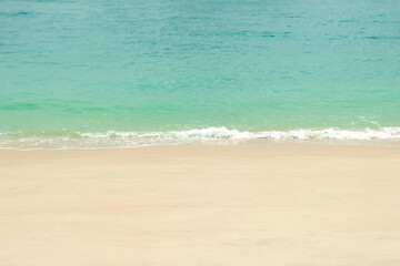 Soft blue ocean wave on clean sandy beach. Sea view from tropical beach.
