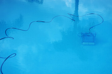 Underwater automatic vacuum cleaner used in hotel pool, cleaning concept