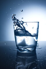 Water splash in glass with ice.