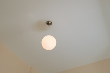 white round lamp hanging from ceiling