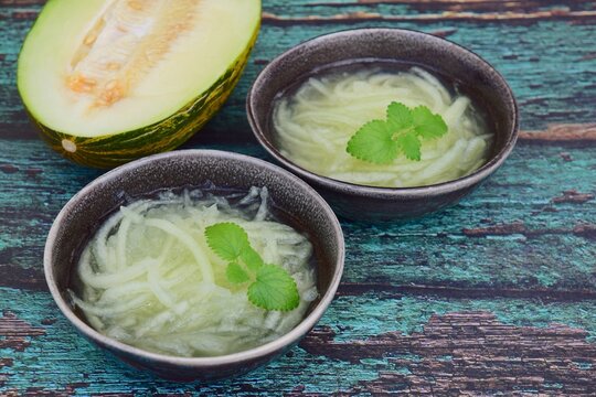 Es Blewah. Indonesian cold fruity drink of melon strips garnish with mint leaf