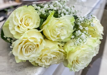 Bouquet of white and green flowers roses greenery closeup