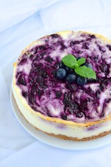 Blueberry cheesecake with mint leaf on white background