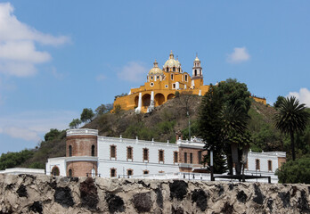 Fototapeta premium A landscape of Cholula, located in a valley of the central Mexican highlands. The Church of the Lady of Remedies and the Regional Museum of Cholula, both built atop the buried Great Temple of Cholula.