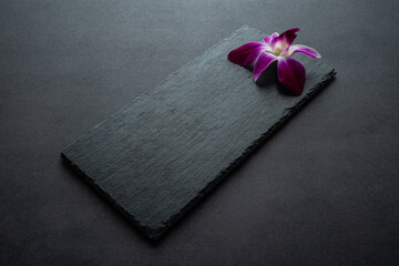 Black slate tray decorated with orchids