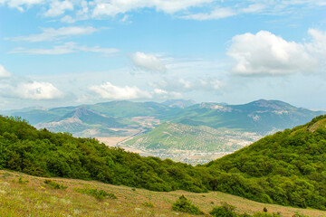 Fototapeta na wymiar Panorama of the Crimean mountains overlooking the city of Sudak on a sunny day.