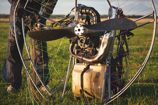 A male pilot is preparing a gasoline-powered paralet for flights. Paragliding for individual paragliding flights. Preparation for wing flight. Extreme sports.