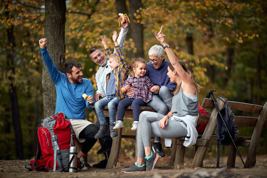 Family with raised arms enjoying in forest