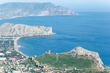 Panorama of the Crimean mountains with a view of the city of Sudak. Fortress view from the mountain on a sunny day.