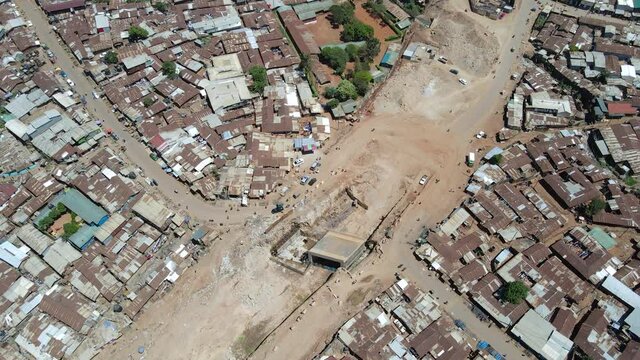 Drone view: Road construction in the slums of kibera kenya- people walking in the poor roads of kibera.