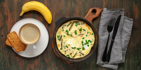 Healthy breakfast - frittata with vegetables and coffee with cookies on the table. Top view