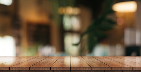 Empty wooden table top with lights bokeh on blur restaurant background.