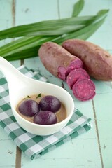 Kolak candil ubi ungu or purple sweet potato glutinous rice balls with pandan, palm sugar and coconut milk sauce