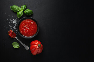 Tomato sauce in bowl on dark