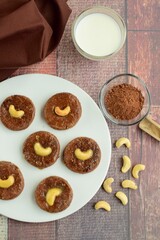 Chocolate cookies with cashew nuts. Served with glass of milk 