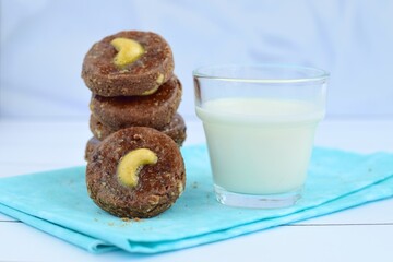 Chocolate cookies with cashew nuts. Served with glass of milk 