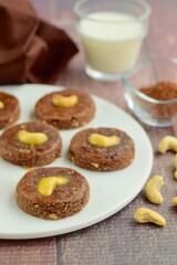 Chocolate cookies with cashew nuts. Served with glass of milk 