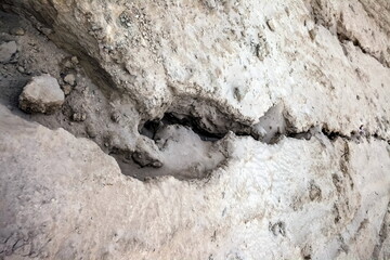Traces of running water on the gray sand. Background