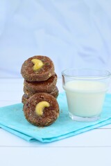 Chocolate cookies with cashew nuts. Served with glass of milk 