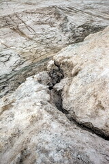 Traces of running water on the gray sand. Background