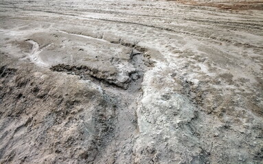 Traces of running water on the gray sand. Background