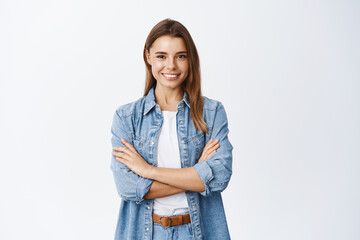 Portrait of smiling confident woman feeling ready and determined, cross arms on chest self-assured...