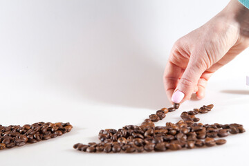 Girl painting a cup of coffee with coffee beans