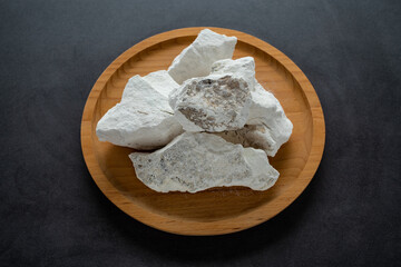 Quicklime chunks on black background