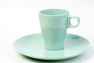 Blue empty plate and cup on a white background. Isolated object