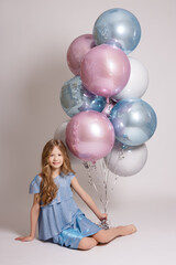 Fototapeta na wymiar happy girl with pastel air balloons over white background.
