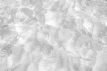 Obraz premium Shadows from the water. Monochrome background with water surface and highlights