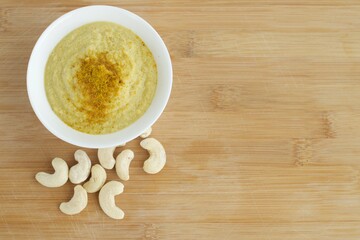 Curry cashew sauce on wooden background
