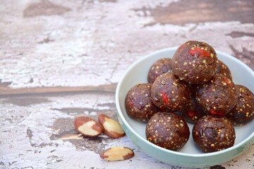 Chocolate goji berry raisin quinoa amaranth Brazil nuts energy balls. Negative space