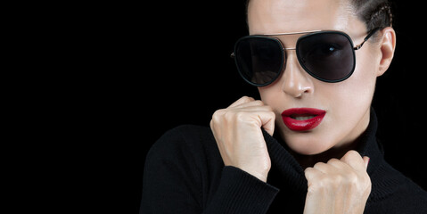 Beautiful young woman wearing black turtle neck and sunglasses