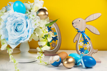 Easter decor, Easter bunny, colored eggs and fake flowers.