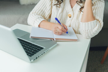 Young beautiful woman is shopping online. Working on the Internet. Home Office.