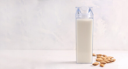 Mock up bottles with almond milk on a white background. Copy space. Banner