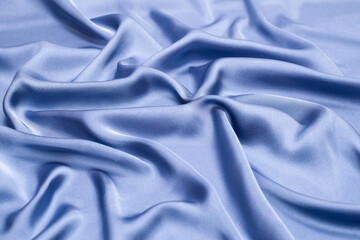 Blue silk or satin luxury fabric texture. Top view.