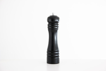 Wooden black pepper grinder mill studio shot isolated on white