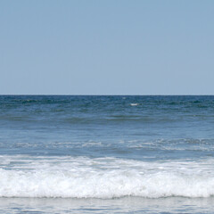 Fototapeta premium Minimalist landscape. Sea waves. Horizon. Blue sky. Simple background.