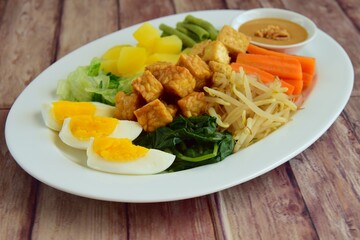 Traditional Indonesian Food, Gado-gado. Made from boiled vegetable, bean sprouts, egg, tempeh and fried tofu served with peanut sauce