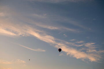Flight of a two balloon in the sky in the morning at sunrise or in the evening at sunset. Travel by air or adventure