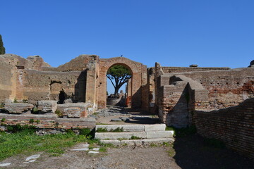 Ancient Roman ruins of houses with brick wall and arches at the archeological site of Ostia Antica Rome Italy 