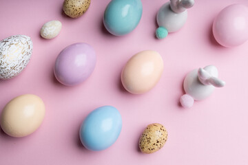 Easter colorful photografie with eggs group and bunny egg  on pink background, copy space 